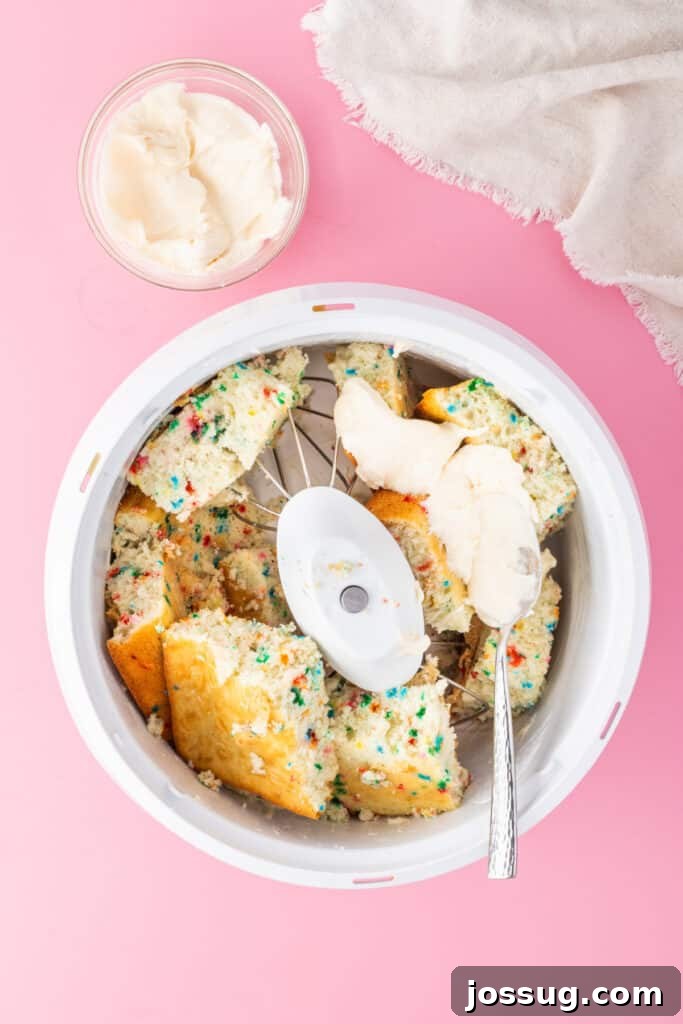 Birthday Cake Bites 7 Crumbled funfetti cake with frosting added in a mixing bowl