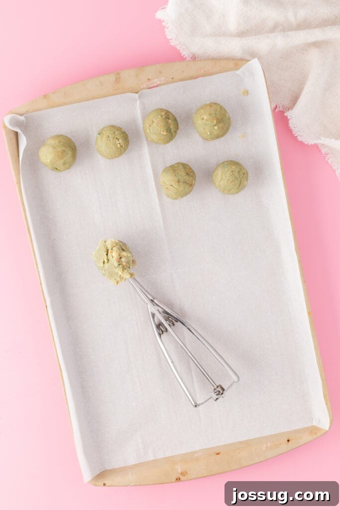 Birthday Cake Bites 8 Cake truffle mixture rolled into balls on a parchment-lined baking sheet