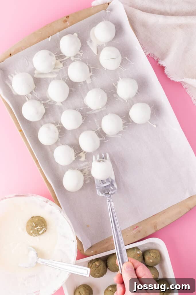 Birthday Cake Bites 9 Cake truffle balls dipped in melted white chocolate on parchment paper