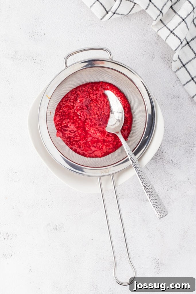Straining raspberry puree