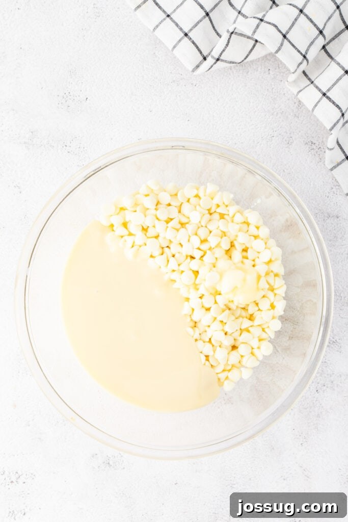 White chocolate chips and sweetened condensed milk in a bowl