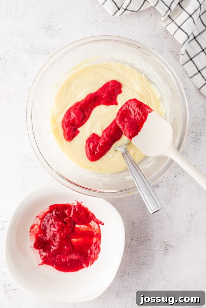 Raspberry puree added to white chocolate mixture