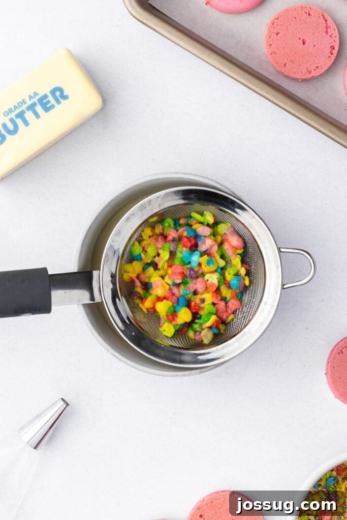 Fruity Pebbles cereal draining in a mesh strainer over a bowl to make cereal milk