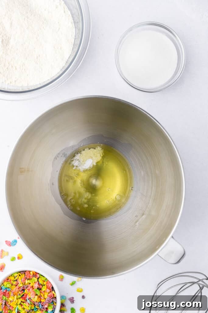 Egg whites and cream of tartar added to a stand mixer bowl before whipping