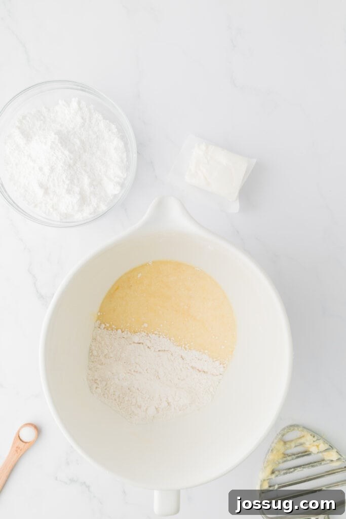 Valentine's Day Mini Treat Cake 9 remaining flour mixture being added to the wet ingredients