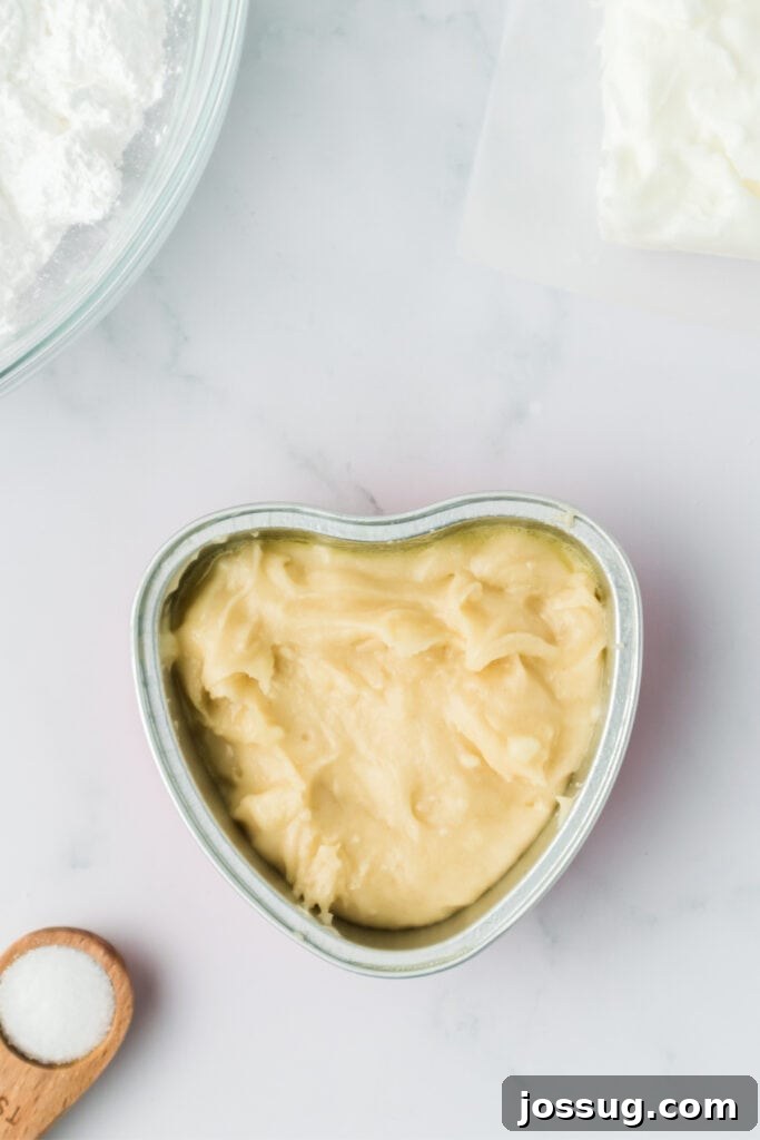 Valentine's Day Mini Treat Cake 10 Cake batter poured into a heart shaped baking pan before baking