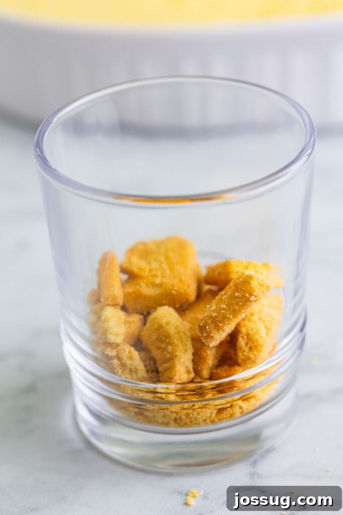 Creme Brulee Dream Trifle 12 Shortbread cookie pieces layered in the bottom of a clear dessert glass, forming the first layer of the trifle.