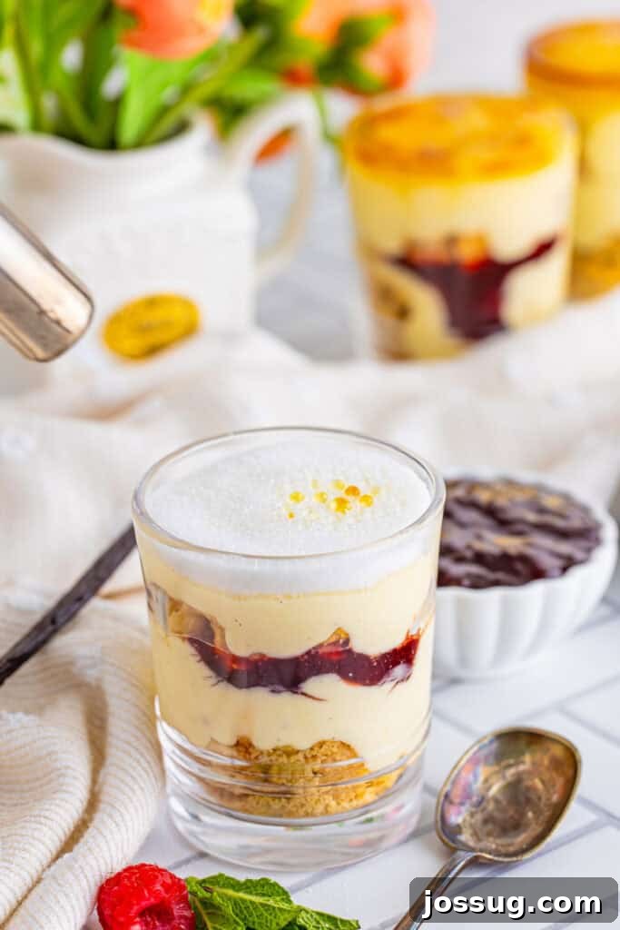 Creme Brulee Dream Trifle 18 Creme brulee trifle with a caramelized sugar topping in a clear glass, showcasing the crackly, golden crust.