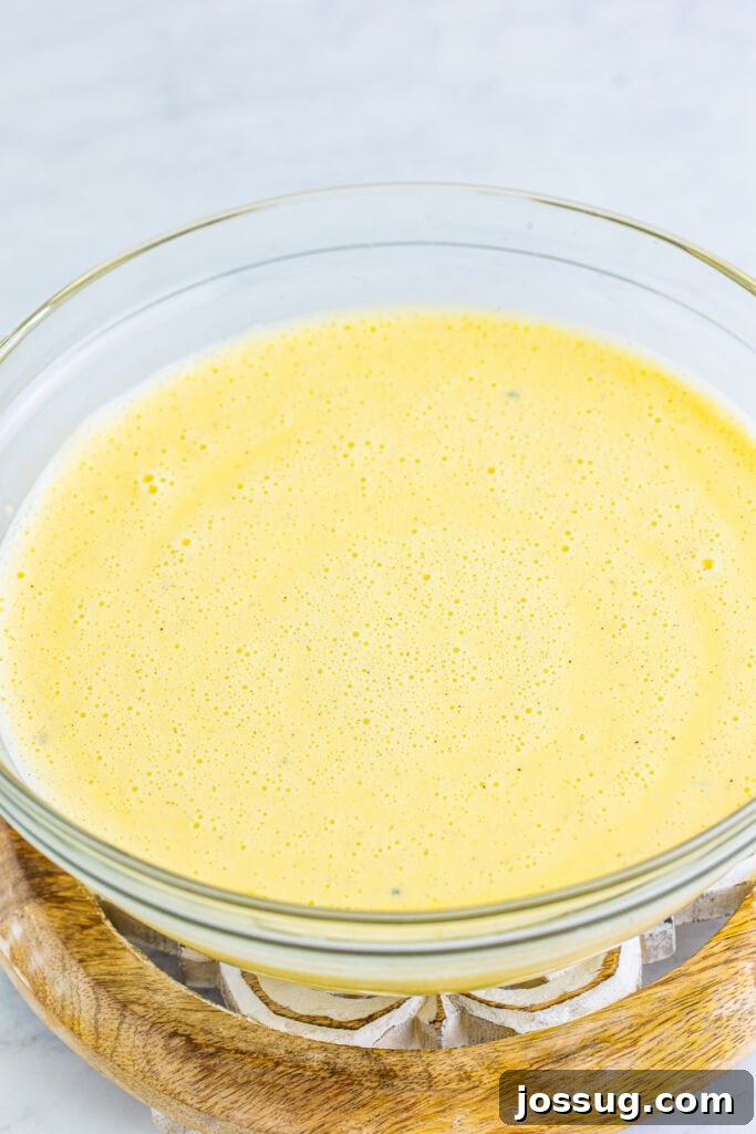 Creme Brulee Dream Trifle 6 Whisked creme brulee custard mixture in a glass bowl, ready for baking.