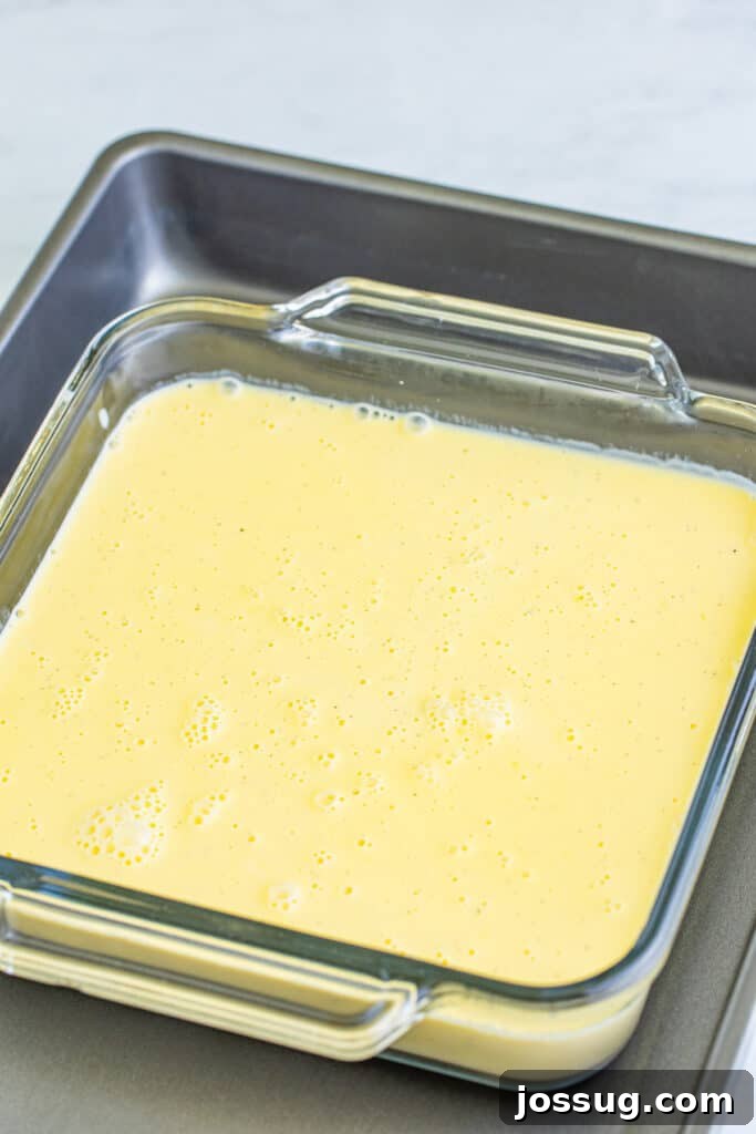 Creme Brulee Dream Trifle 8 Creme brulee custard poured into a glass baking dish, set inside a roasting pan for a water bath.