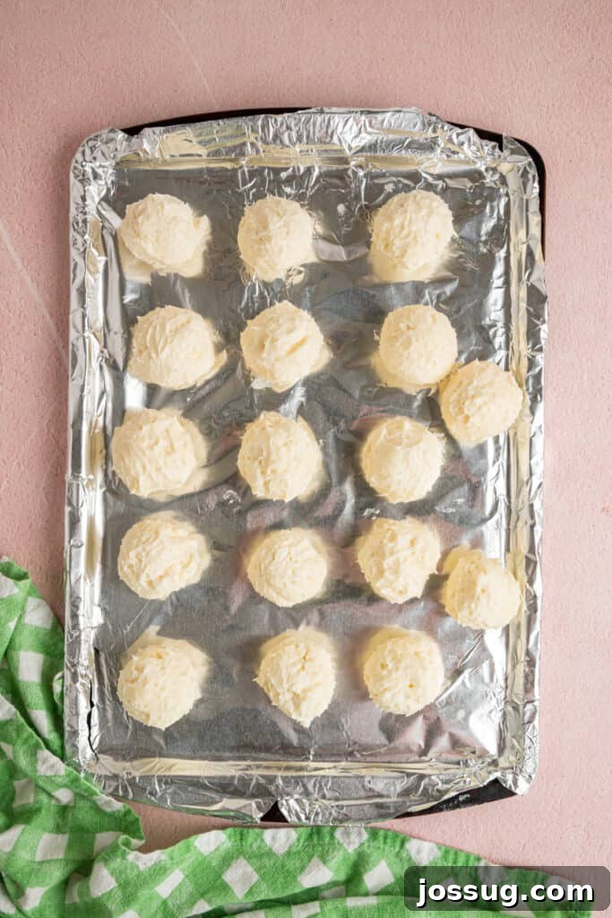 Buttercream Bliss Bites 12 Buttercream balls arranged on a foil lined baking sheet before chilling