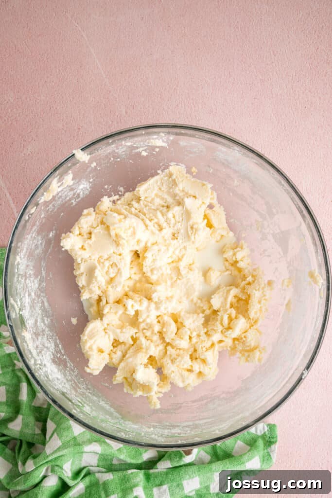 Buttercream Bliss Bites 8 Thick buttercream mixture with milk added to the top forming in a glass mixing bowl