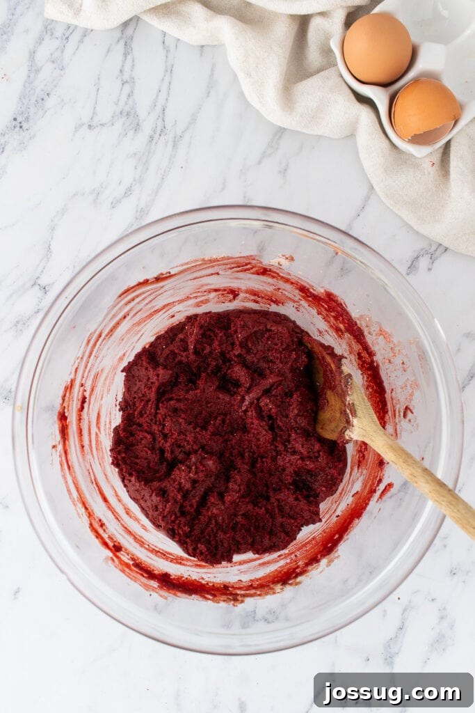 Thick red velvet brownie batter in a glass bowl