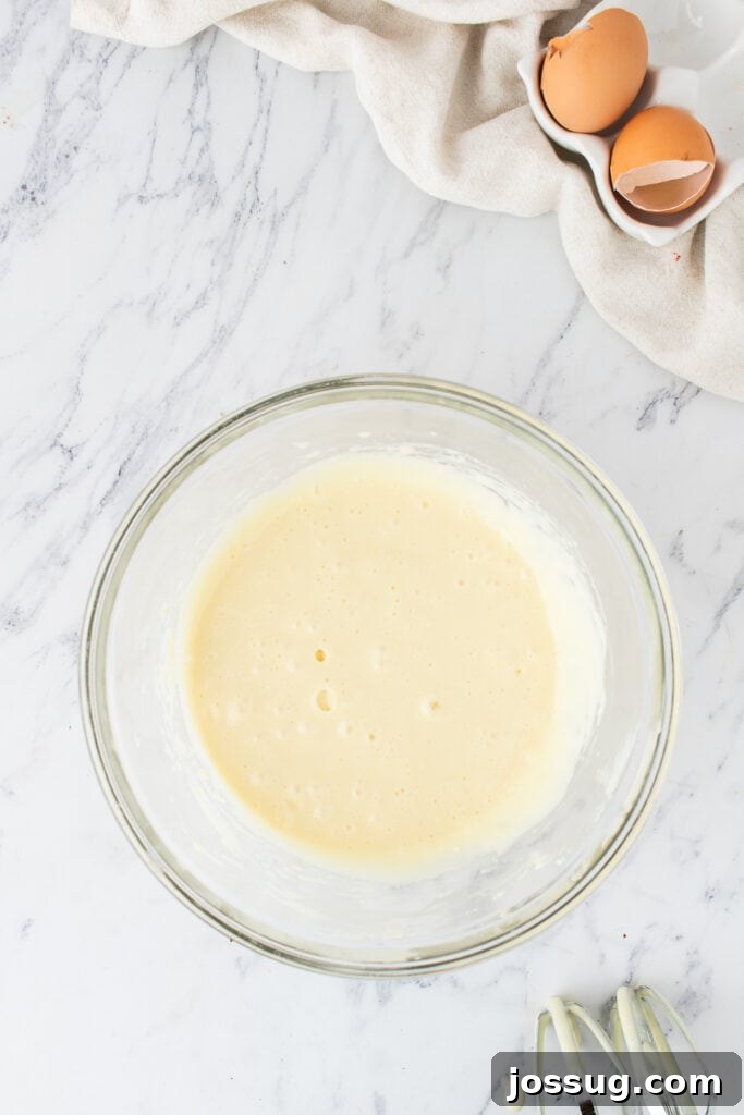 Smooth cream cheese mixture in a glass bowl