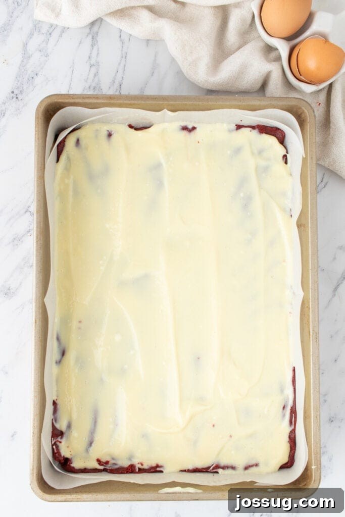 Cream cheese layer spread over the brownie batter