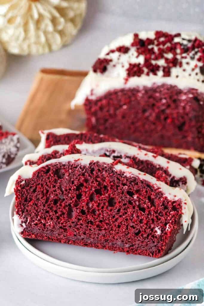 Red Velvet Dream Loaf 2 Close-up of a slice of red velvet loaf with cream cheese frosting