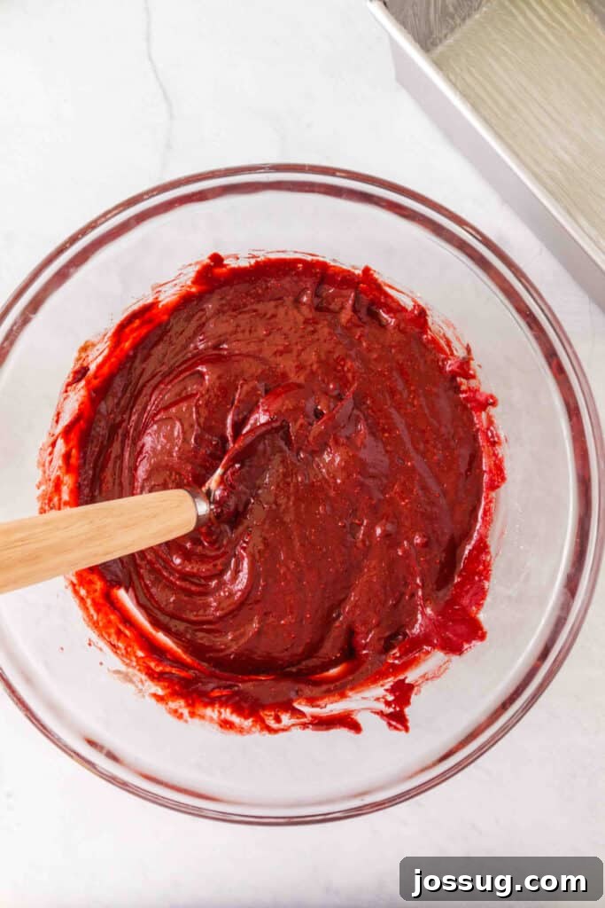 Red Velvet Dream Loaf 4 Bright red velvet batter being stirred with a spatula