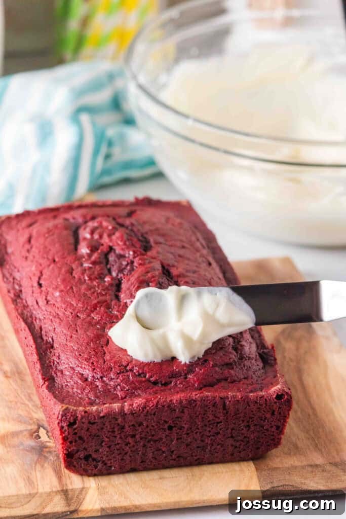 Red Velvet Dream Loaf 7 Spreading cream cheese frosting over the baked loaf