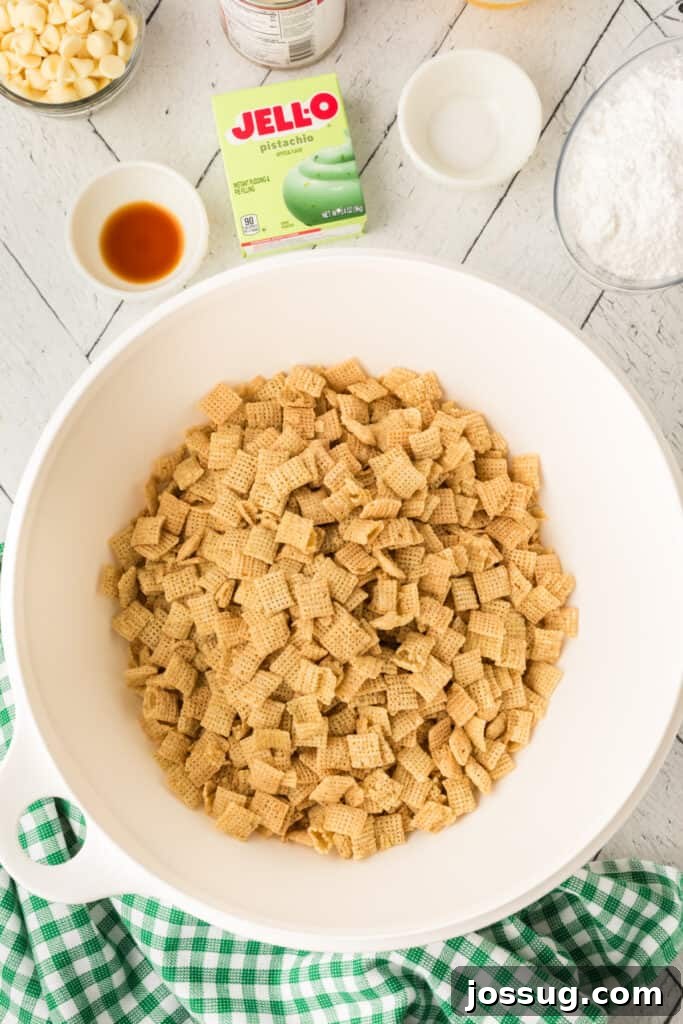 Pistachio Puppy Chow 3 Rice Chex cereal in a bowl with ingredients nearby.