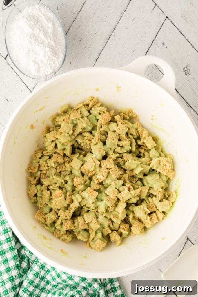 Pistachio Puppy Chow 10 Cereal coated in green pistachio mixture.