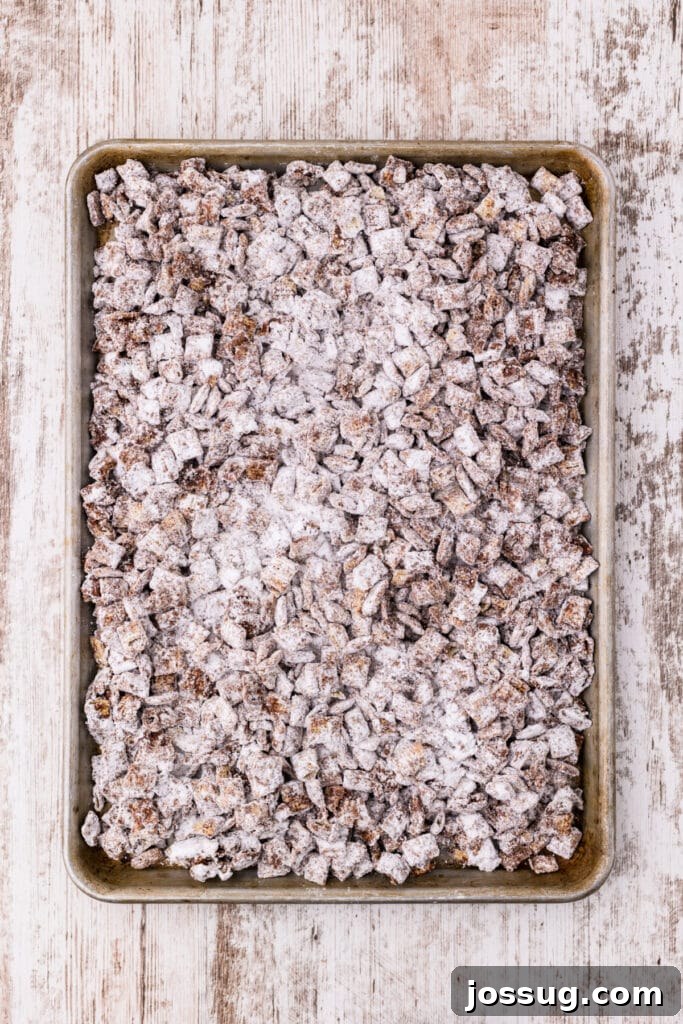 Powdered sugar-coated Rice Chex cereal on a baking sheet