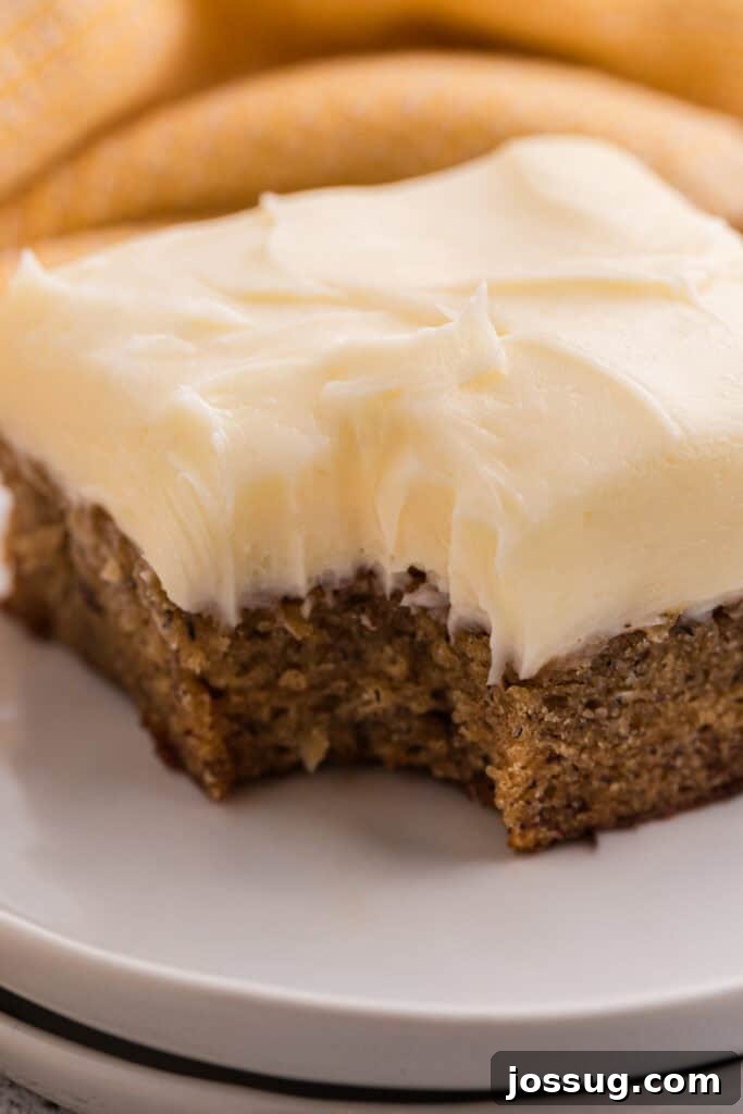 Banana Bread Brownies 17 Close up side view of a banana brownie square with cream cheese frosting showing the crumb texture