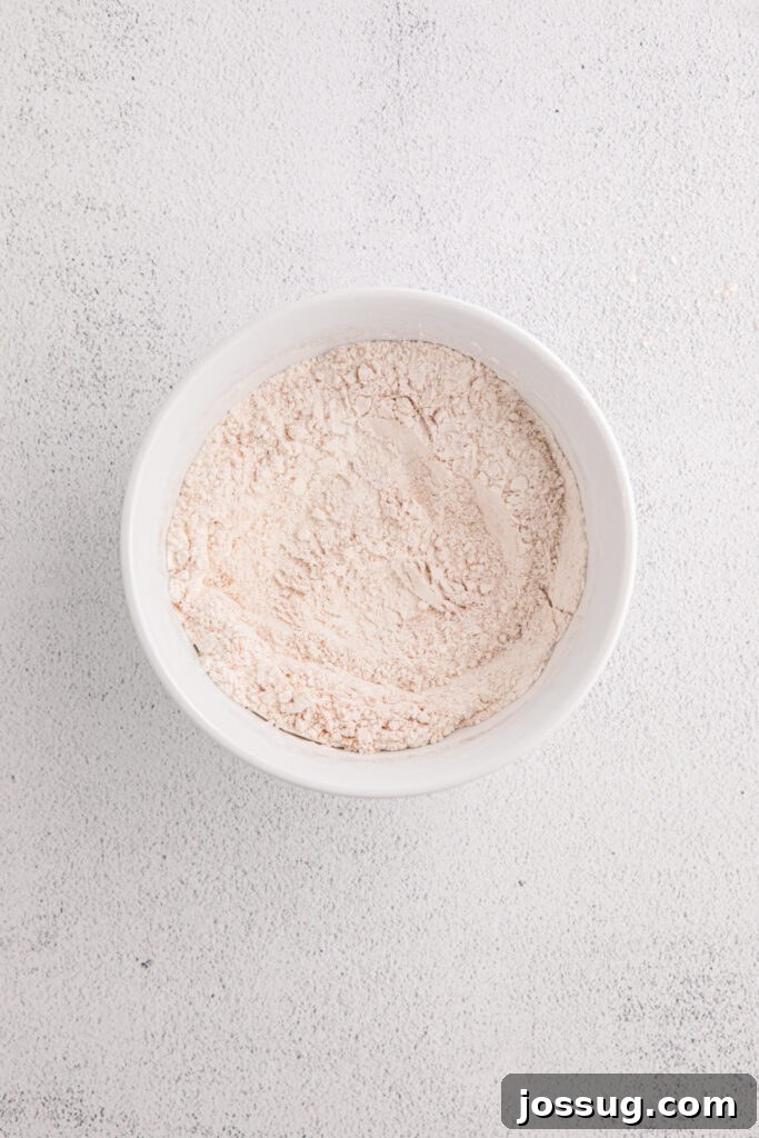 Banana Bread Brownies 4 White bowl with dry ingredients whisked together on a light textured surface
