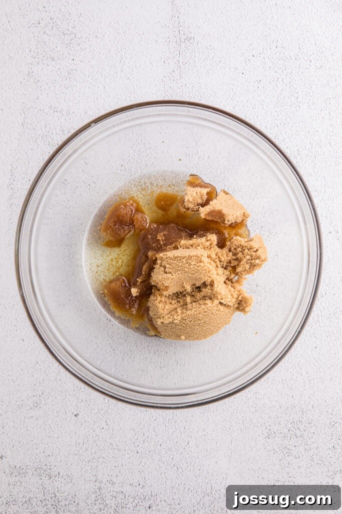 Banana Bread Brownies 5 Glass mixing bowl with melted oil and packed brown sugar