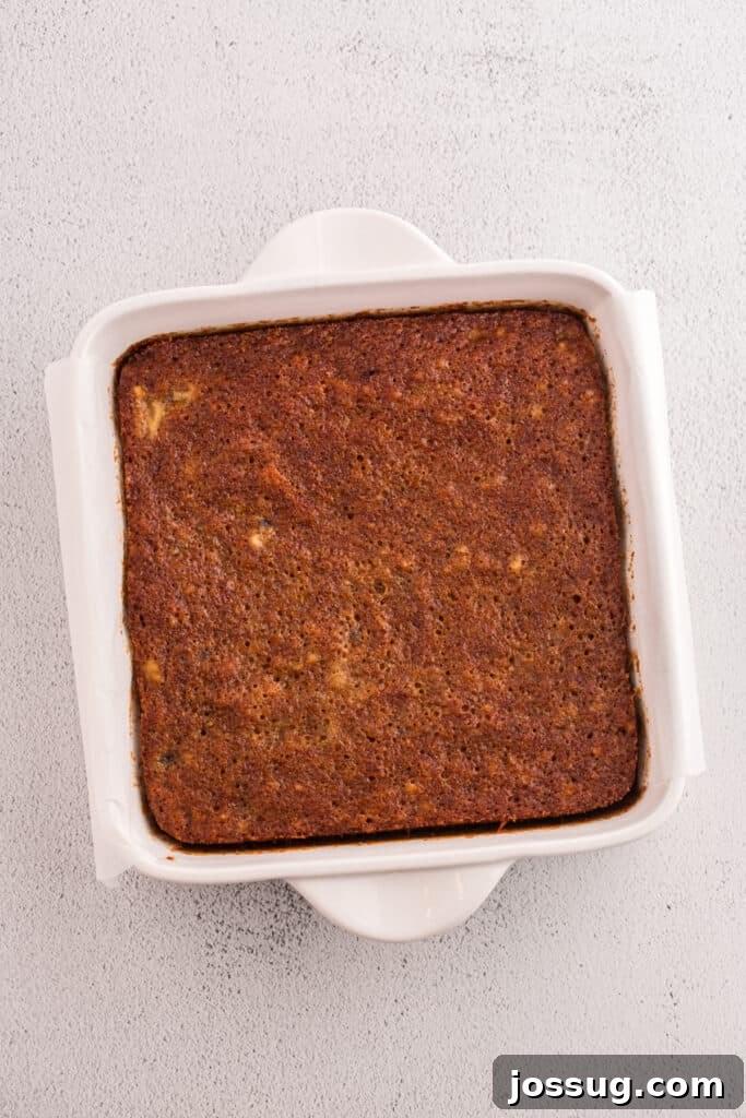 Banana Bread Brownies 10 Baked banana brownie layer in square pan lined with parchment paper