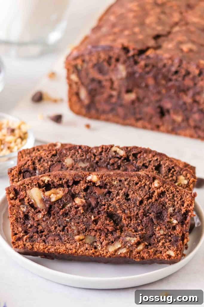 Brownie-Swirled Banana Bread 2 Close up of sliced brownie banana bread showing chocolate chips and walnuts inside.