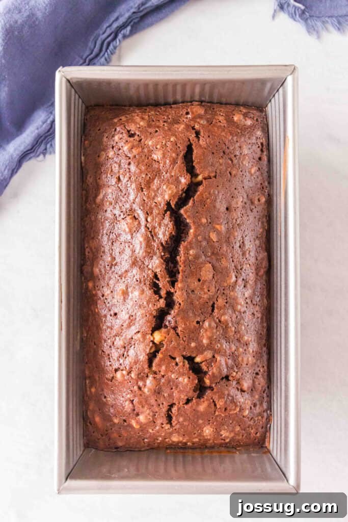 Brownie-Swirled Banana Bread 7 Baked brownie banana bread loaf in a metal loaf pan with a crack down the center.