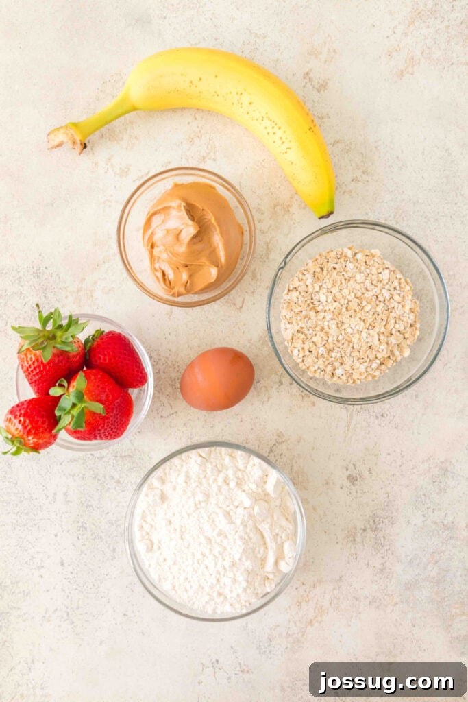 Ingredients for Strawberry Banana Dog Treats: banana, strawberries, peanut butter, oats, flour, and egg.