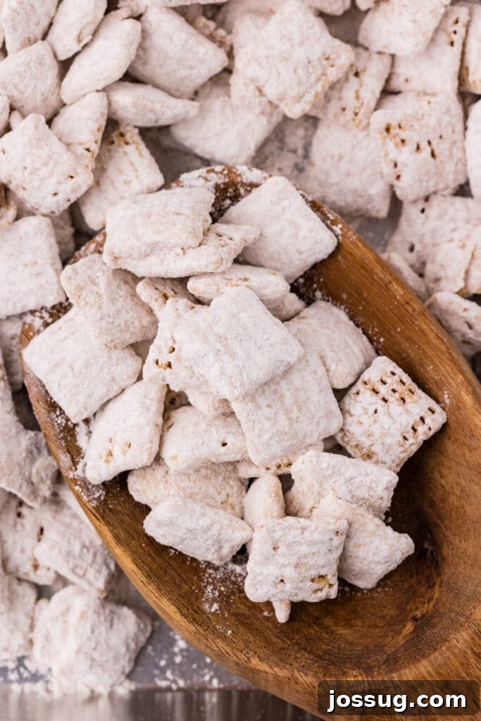 Carrot Cake Muddy Buddies: A Festive Spring Treat 12 Carrot cake muddy buddies in a wooden spoon close-up