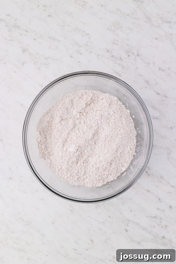 Carrot Cake Muddy Buddies: A Festive Spring Treat 6 Combined powdered sugar mixture with carrot cake mix and spices in a bowl