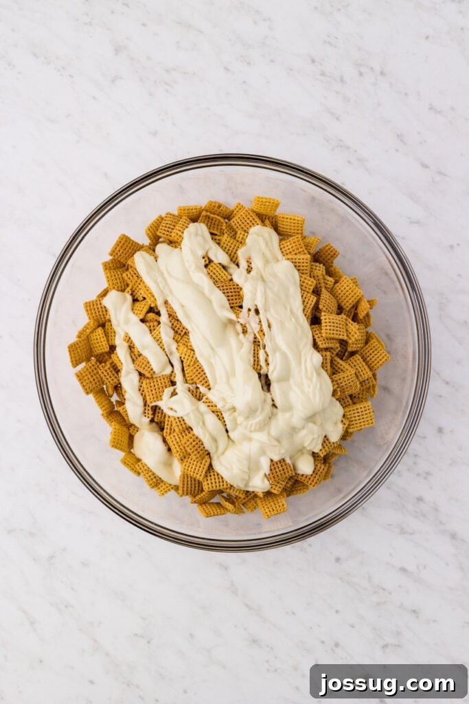 Carrot Cake Muddy Buddies: A Festive Spring Treat 8 White chocolate poured over Corn Chex cereal in a mixing bowl