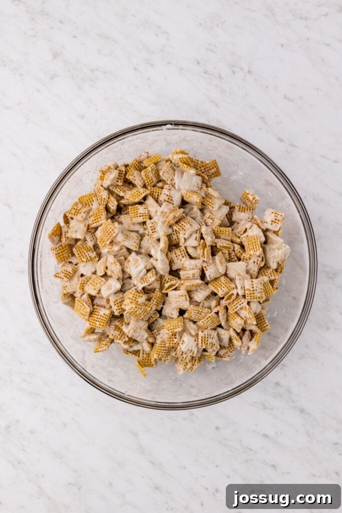 Carrot Cake Muddy Buddies: A Festive Spring Treat 9 Cereal coated in melted white chocolate in a large bowl
