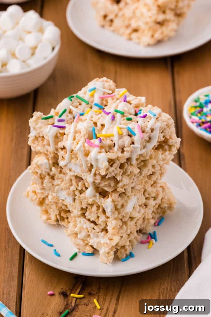 Lemon Rice Crispy Treats topped with white drizzle and colorful sprinkles