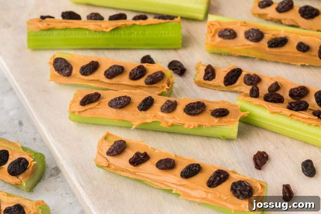 Ants on a Log: A Fun & Healthy Snack for Kids 4 Close view of celery sticks with peanut butter and raisins on a wooden board