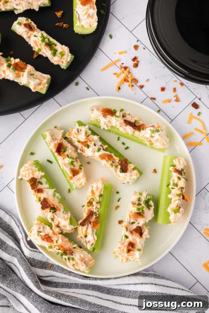 Close overhead view of filled celery sticks on a plate before garnish