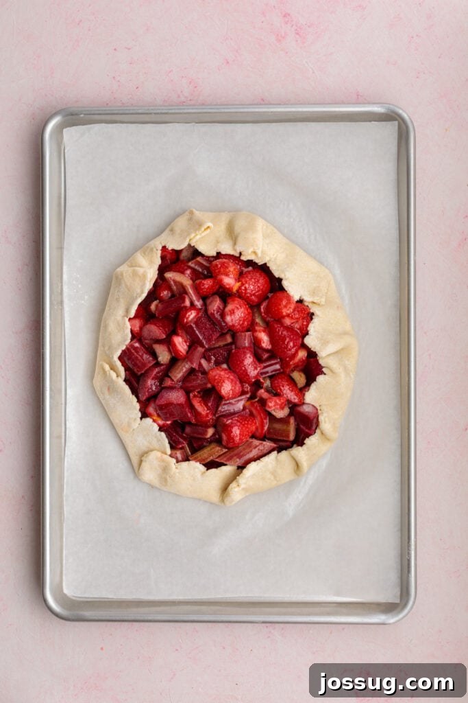 Simply Irresistible Strawberry Rhubarb Galette 15 The galette dough is skillfully folded over the luscious strawberry and rhubarb filling, creating a beautiful, rustic, free-form crust around the fruit.
