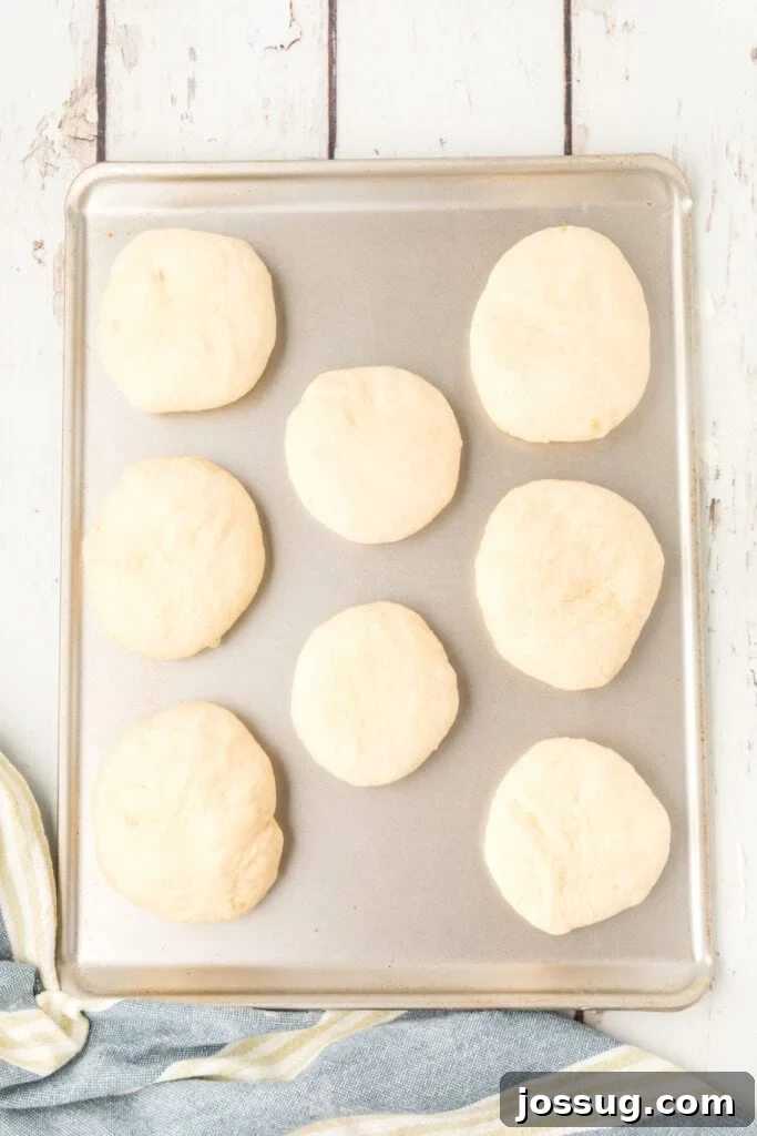 shaped homemade onion rolls dough on a baking sheet before rising