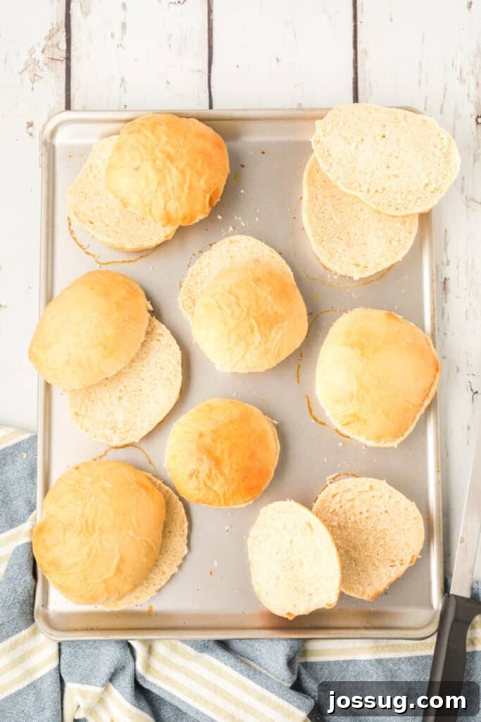 sliced homemade onion rolls on a baking sheet showing soft interior texture