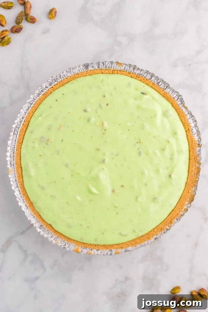 Quick No Bake Pistachio Delight 14 The smooth and creamy pistachio pie filling is evenly spread into a waiting graham cracker crust, ready to be covered and chilled until perfectly set.
