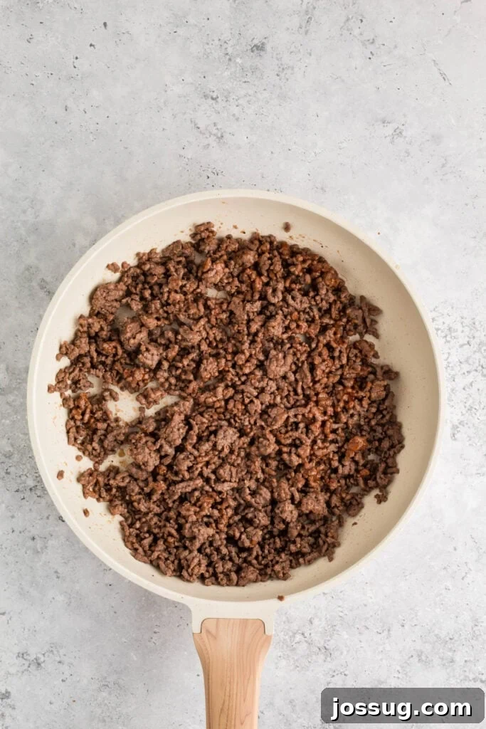 cooked ground beef mixed with ketchup in a skillet