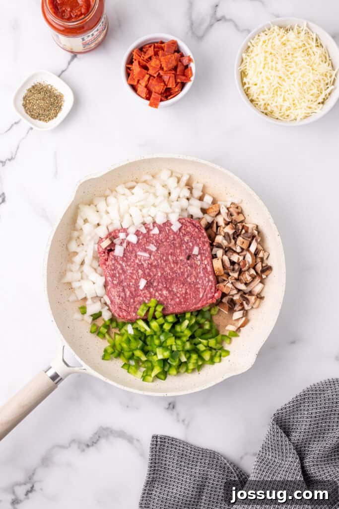 Easy Ground Beef Pizza Sloppy Joes 5 ground beef, chopped onion, green pepper, and mushrooms in a skillet before cooking for Pizza Sloppy Joes