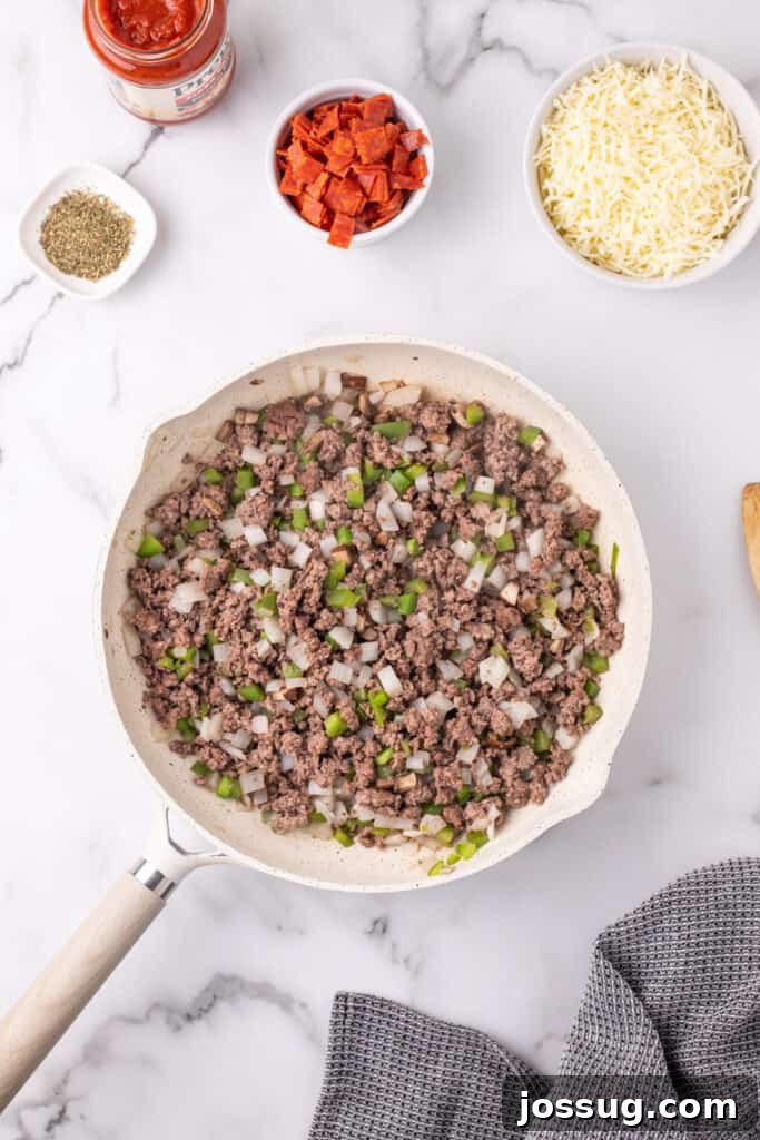 Easy Ground Beef Pizza Sloppy Joes 6 cooked ground beef mixture with onions, green pepper, and mushrooms in a skillet for Pizza Sloppy Joes