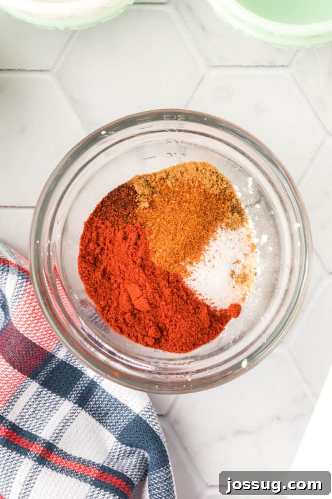 A glass bowl containing all the unmixed spices for the fajita seasoning recipe.