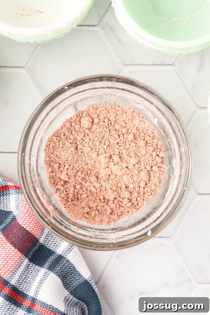 The fajita seasoning spices fully blended together into a uniform red-brown mixture in a glass bowl.