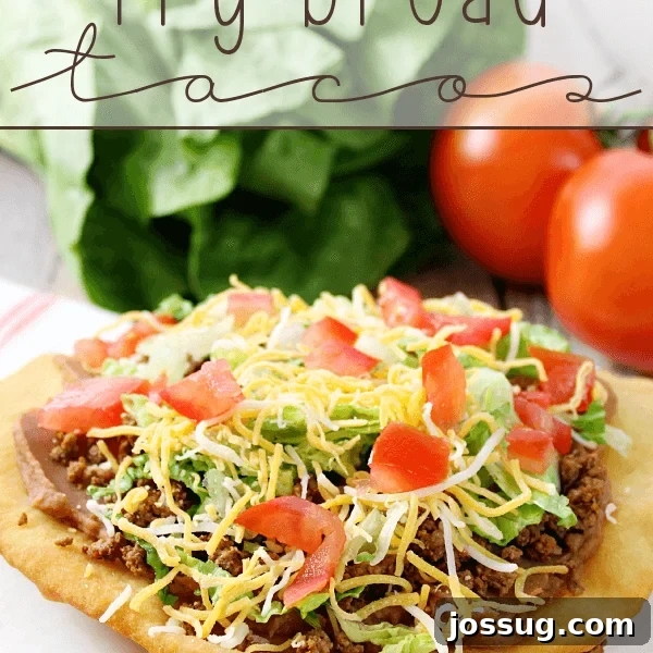 Crockpot Shredded Chicken Tacos Recipe for Busy Weeknights 13 Fry Bread Taco on a white plate with fresh vegetables.