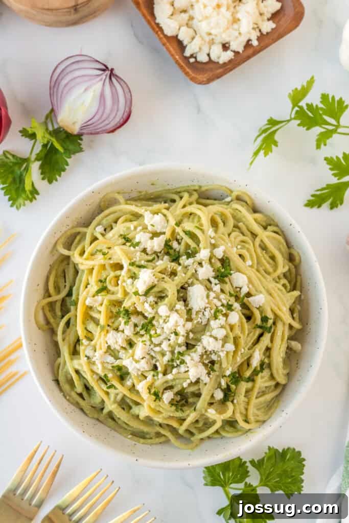 Creamy Mexican Verde Spaghetti (Espagueti Verde) 2 Overhead view of Mexican Green Spaghetti topped with queso fresco and cilantro